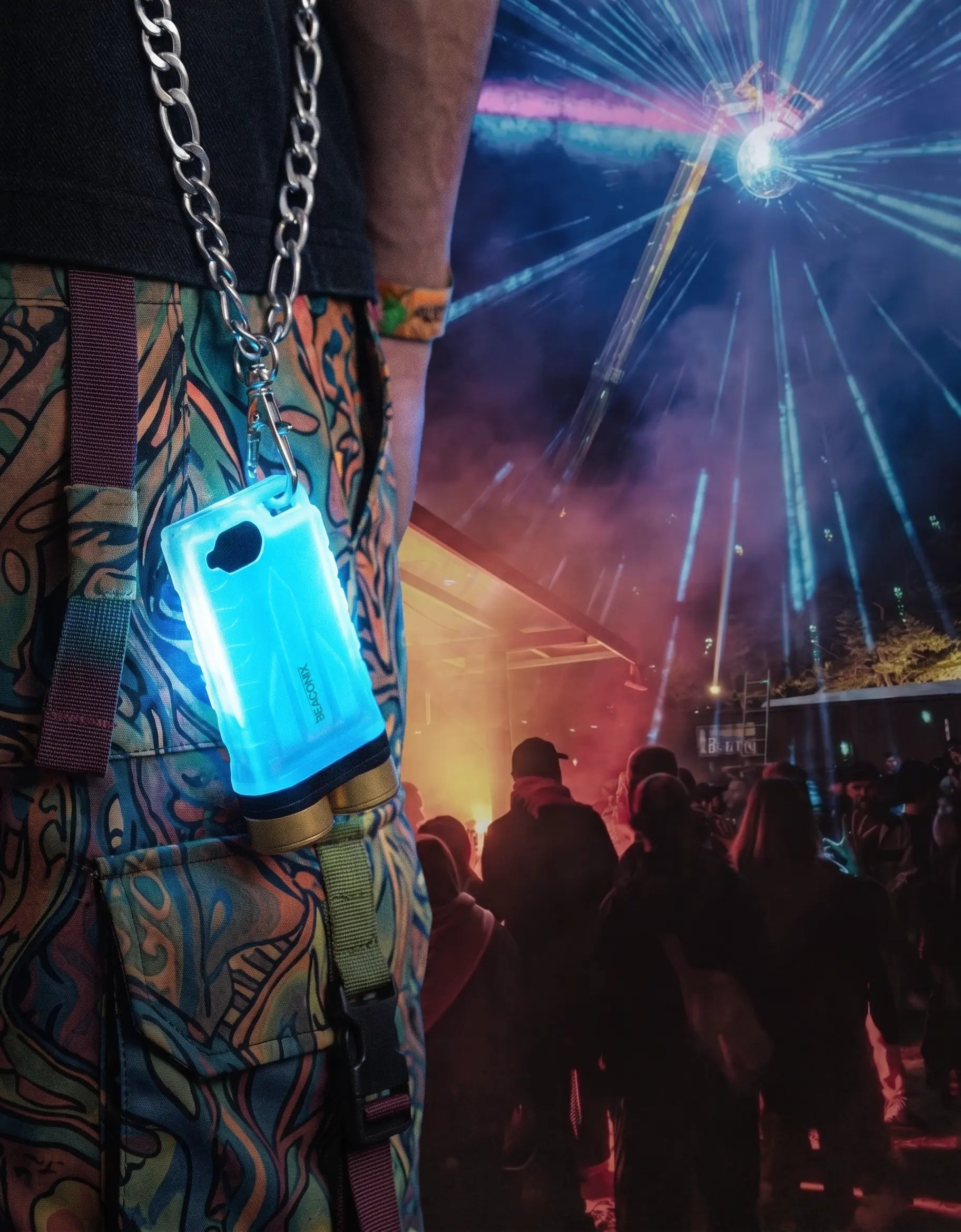 Beaconix B3 Mini glowing blue on a chain at a night festival