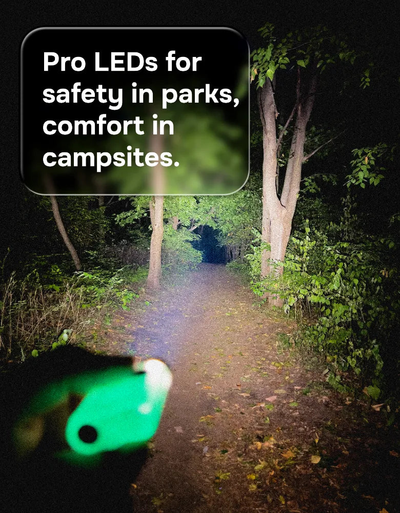 Beaconix B3 Mini glowing green on a night trail, lighting the path
